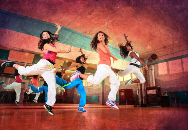 group of  women in sport dress at fitness dance exercise or aerobics